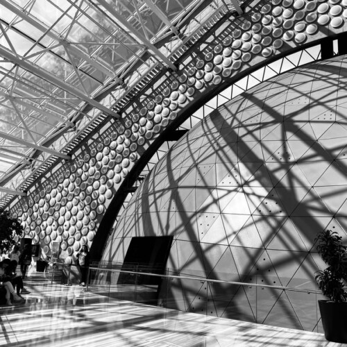 a black and white photo of people sitting on benches